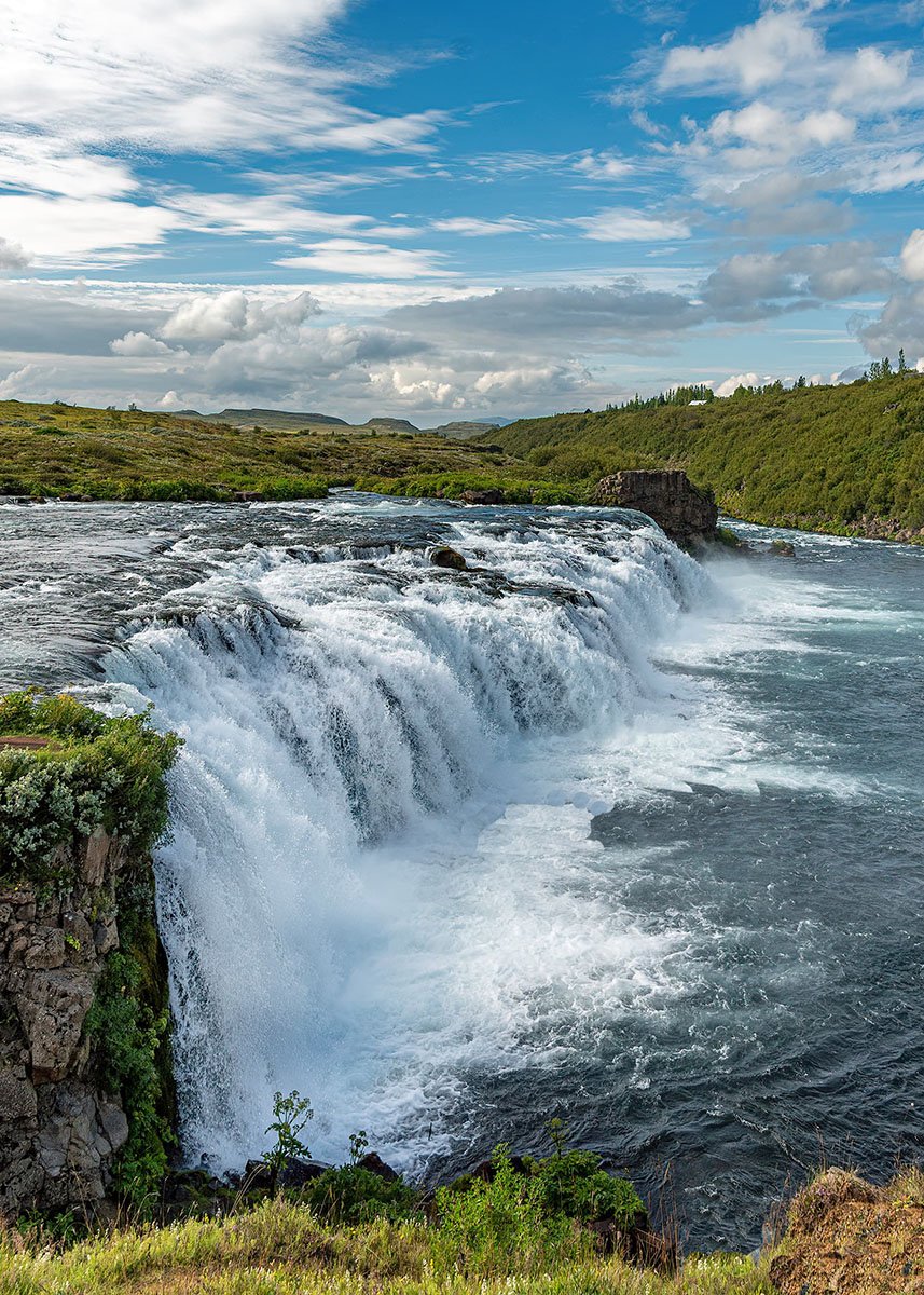 Faxi waterfall on a sunny day with a clear blue sky