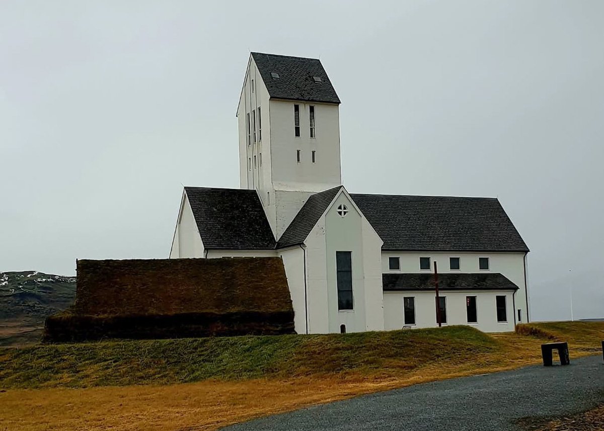 Skalholt cathedral with its white exterior and dark roofs in autumn.