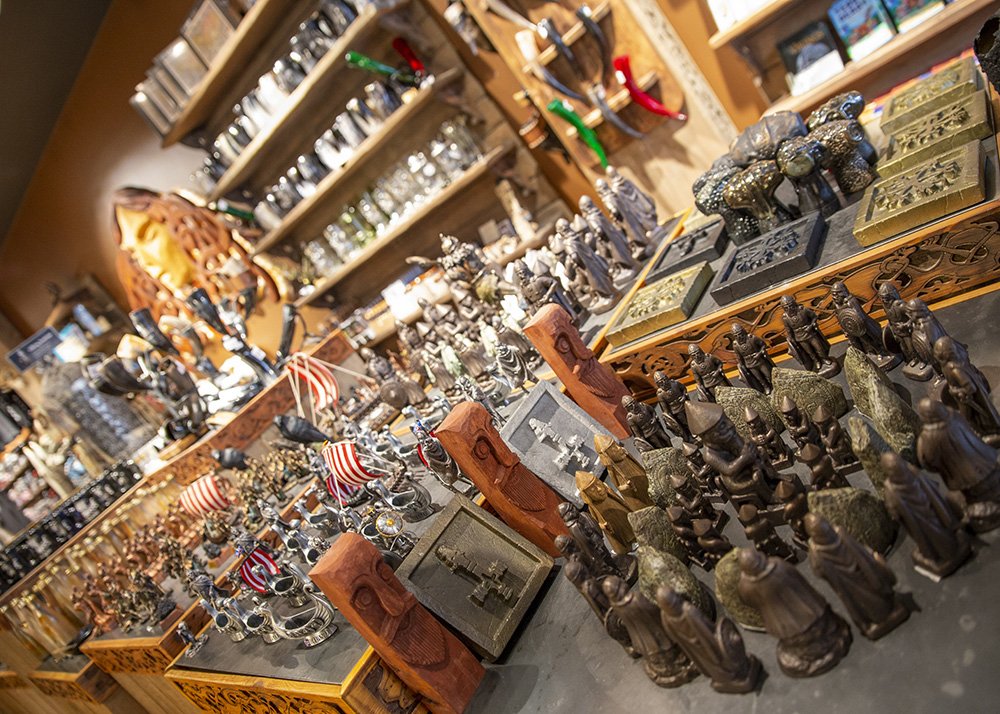 A shop display filled with various souvenirs and collectibles, including Viking-themed items, figurines, and other Nordic decorations.