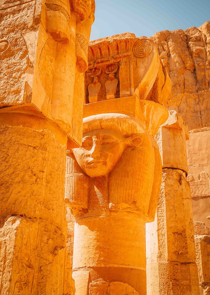 Detailed view of the statues of Pharaoh Hatshepsut at the Mortuary Temple of Hatshepsut, showing the intricate carvings and the stone facade.