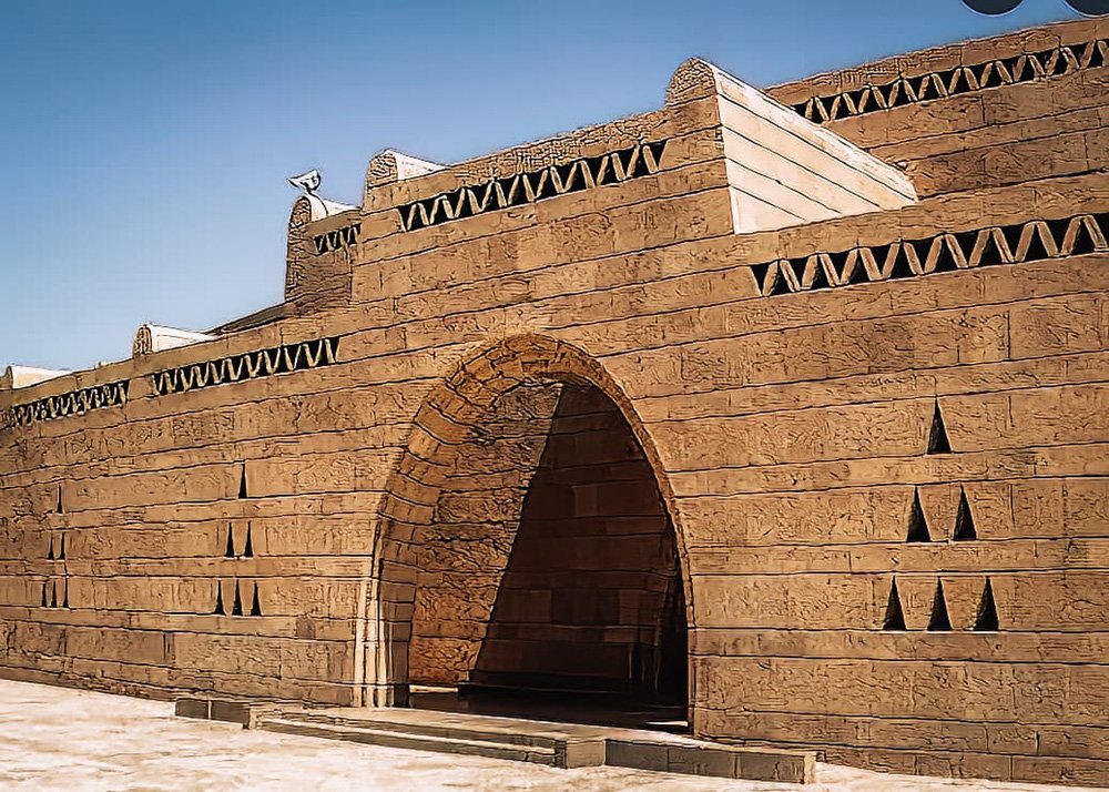 Wide shot of the entrance of the Nubian Museum. A bricked building with an arch as an entrance