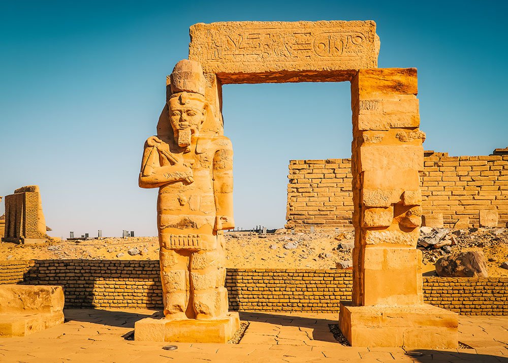 Arch with the statue of a pharaoh on the left side at the Temple of Kalabsha