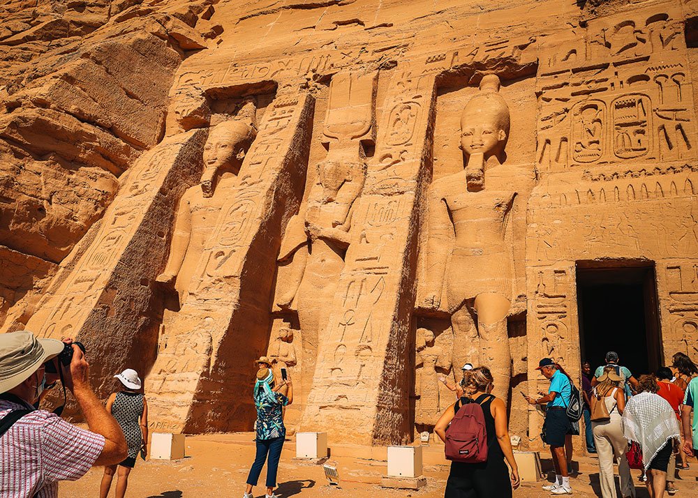Close-up of the beautifully carved facade of Nefertari's Temple, featuring statues of the queen and hieroglyphic inscriptions.