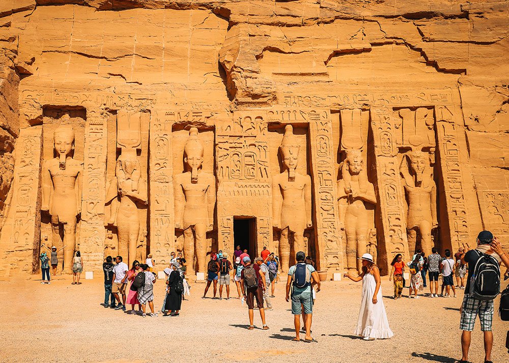 The facade of Nefertari's Temple at Abu Simbel, showcasing detailed carvings and statues of the queen and gods.