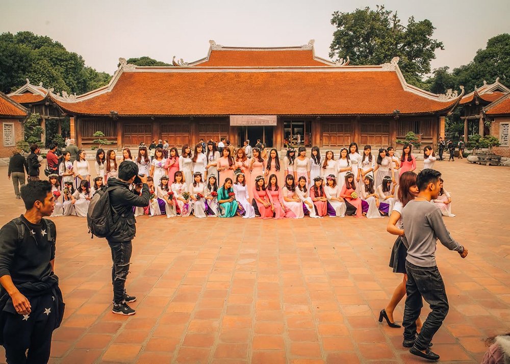 Girls taking their class graduation pic at the Temple of Literature in Hanoi, Vietnam: Graduating students posing for photos at the Temple of Literature.