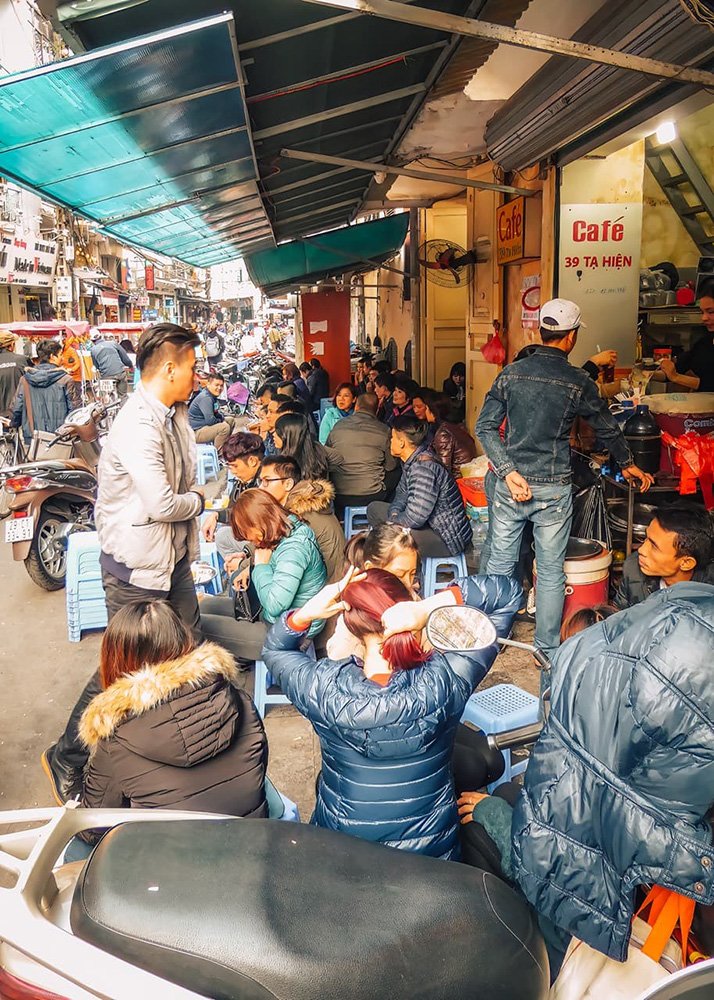Locals having breakfast in the Old Quarter of Hanoi - Vietnam: Local residents enjoying a traditional breakfast in the vibrant Old Quarter of Hanoi.