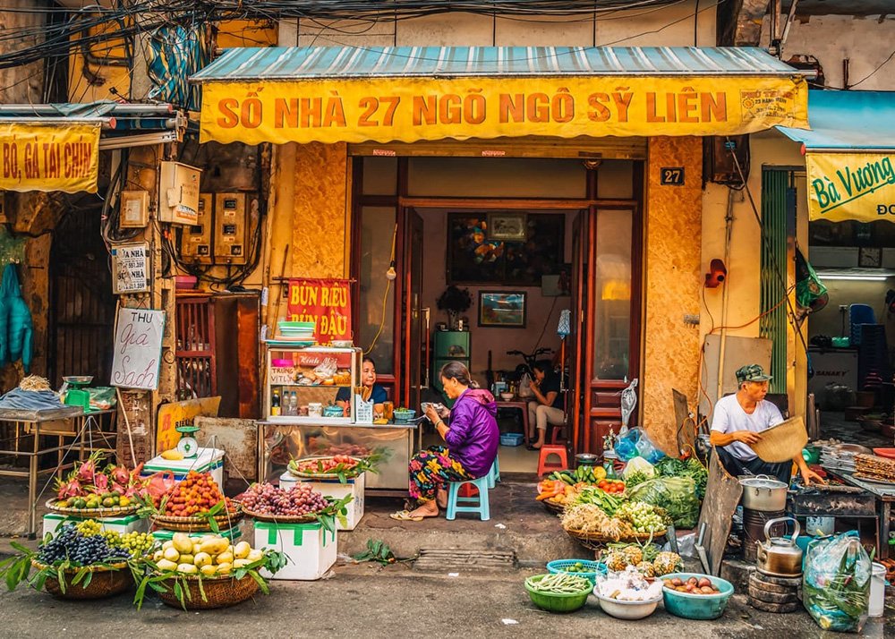 Shop and street food vendor in one in the Old Quarter of Hanoi in Vietnam: A bustling shop that also serves as a street food vendor in Hanoi's Old Quarter.