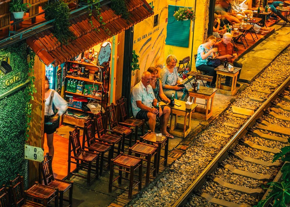 Tourists enjoying a drink in Hanoi's famous Train street - Vietnam: Tourists sitting and having drinks along the famous Train Street in Hanoi.