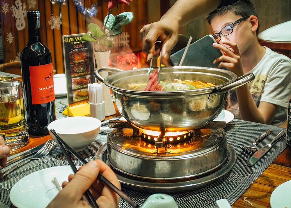 Eating the Vietnamese version of a Hot Pot in Ho Chi Minh City - Vietnam: Close-up of a hot pot meal being enjoyed at a restaurant in Ho Chi Minh City.