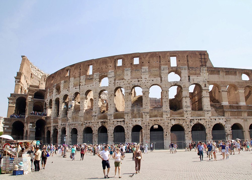 Colosseum in Rome: The iconic Colosseum in Rome, bustling with visitors exploring the ancient amphitheater, capturing the grandeur and historical significance of this famous landmark.