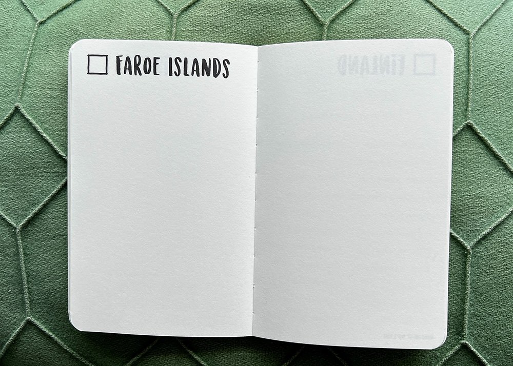 An open page in The Adventure Book with a check box and "Faroe Islands" written next to it. This page is empty and ready to be filled by the buyer of the journal.