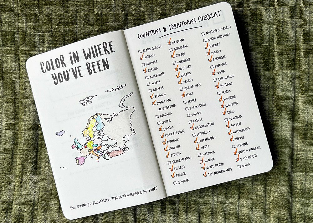 An open page from the Europe Edition of "The Adventure Book" titled "Color In Where You've Been," featuring a map of Europe and a checklist of countries and territories to visit. Some countries are colored in, indicating visited places.