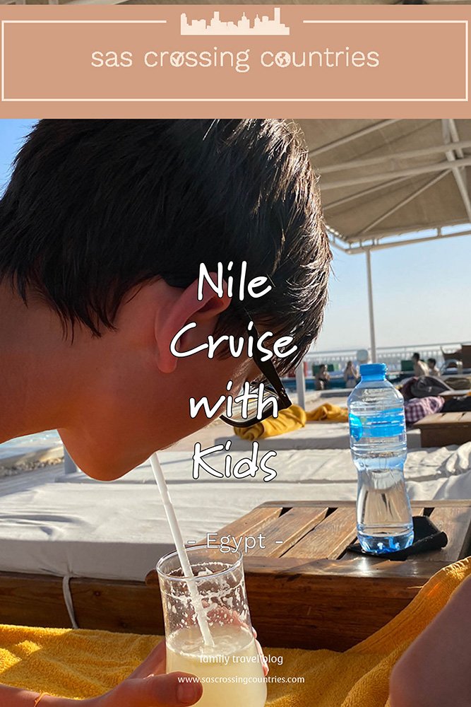 Cover image for a family travel blog post titled "Nile Cruise with Kids," showcasing a a teen lying on a sunbed sipping from a lemon juice in a cocktail glass enjoying the view of the Nile river. The blog URL "www.sascrossingcountries.com" is visible at the bottom.