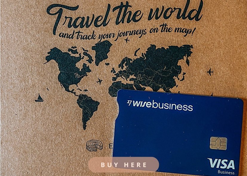 A black drawing of a world map with a quote "Travel the world" and on top of that a blue Wise business travel card and the text "buy here". Clicking this picture will lead you to the homepage of Wise.