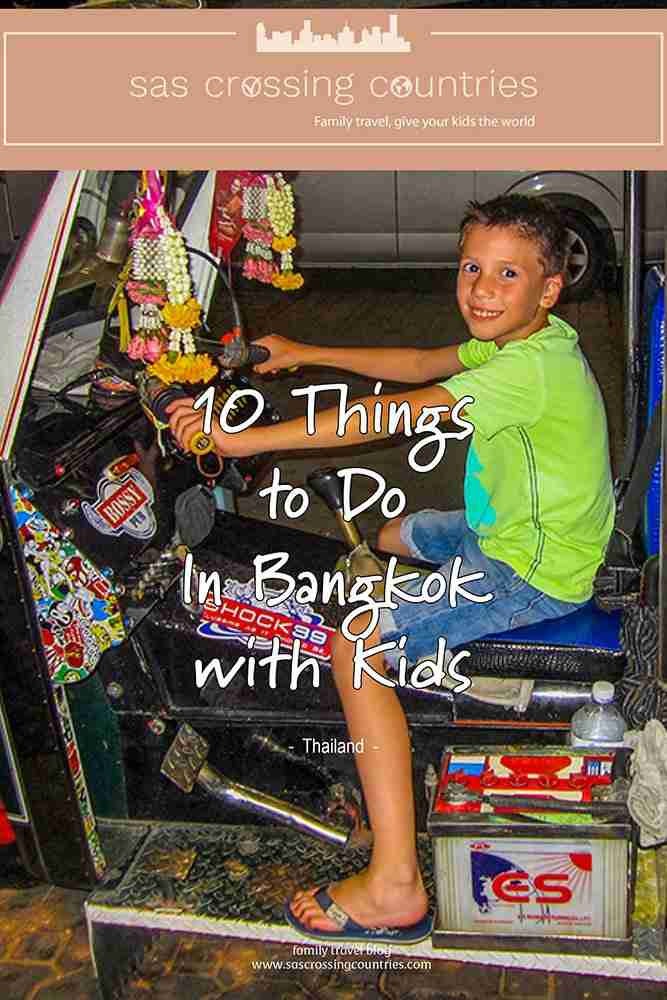 Cover image for a family travel blog post titled "10 Things to Do In Bangkok with Kids" showcasing young boy sitting behind the wheel of a parked tuk tuk. The blog URL "www.sascrossingcountries.com" is visible at the bottom.