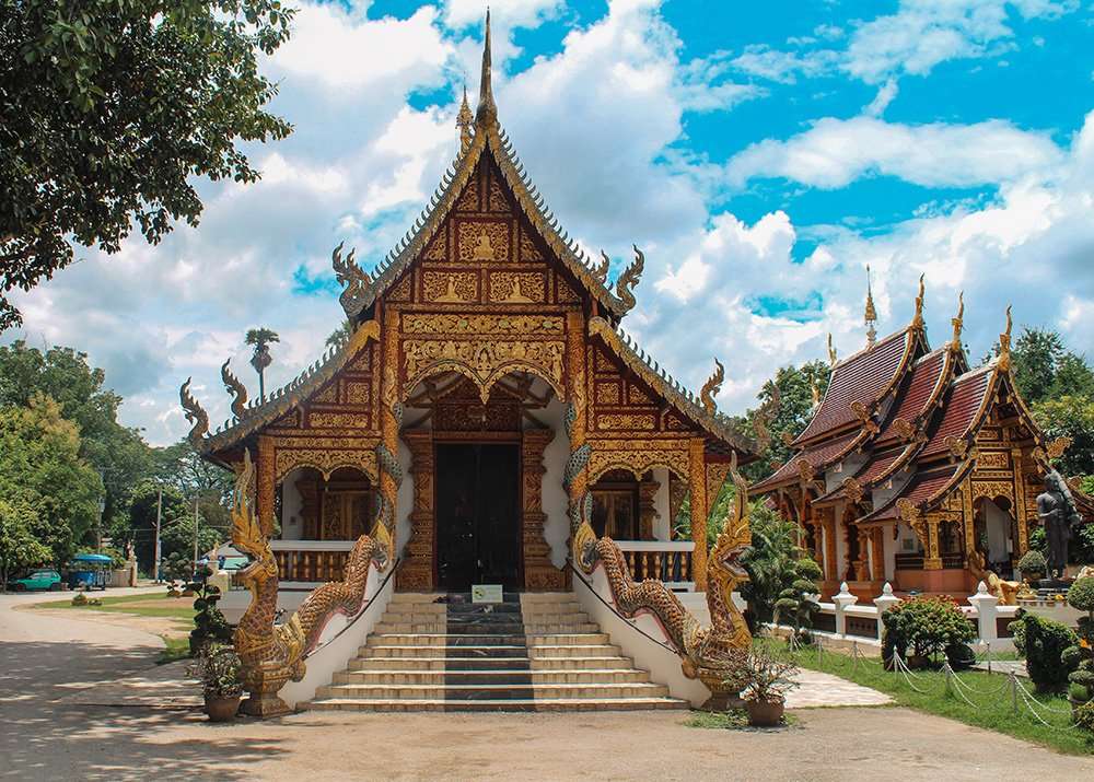 Ornate Buddhist temple with intricate golden details in Chiang Mai, Thailand.
