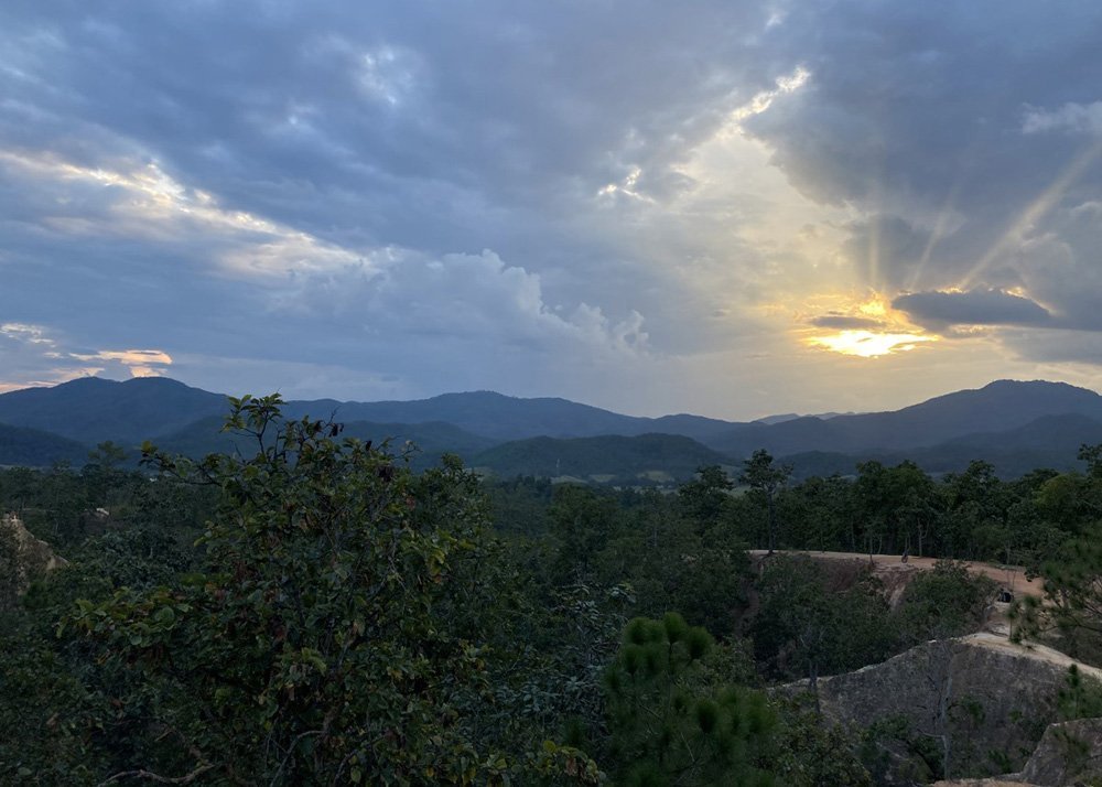 Sunset over Pai Canyon with mountainous landscape in the background, Thailand.