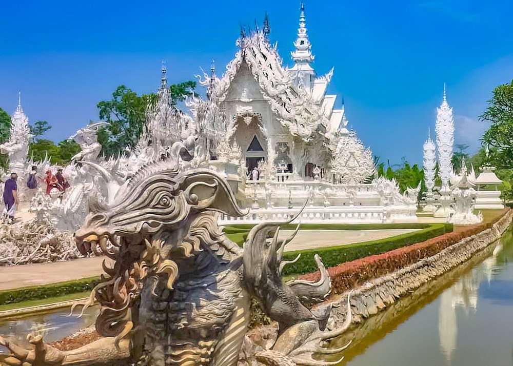 The intricate and white ornate structure of Wat Rong Khun (White Temple) in Chiang Rai, Thailand.