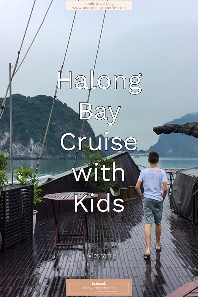 Cover image for a family travel blog post titled "Halong Bay cruise with kids" showcasing a boy walking on the deck of a cruise ship with a dark wooden floor. He has his hands in his pockets and is admiring the view of Halong Bay. The blog URL "www.sascrossingcountries.com" is visible at the top.