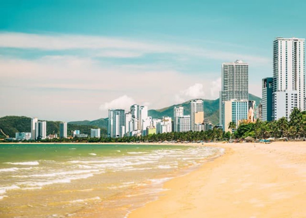 The beach of Nha Trang in Vietnam: A pristine beach with clear blue waters and gentle waves in Nha Trang, Vietnam.