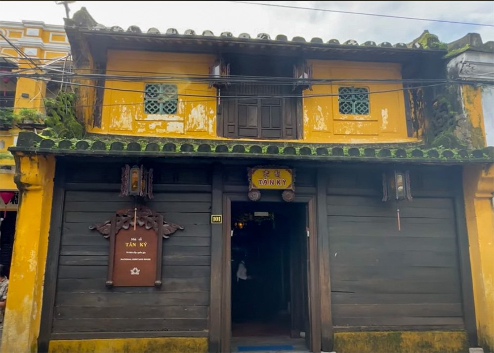 The yellow painted and dark wooden front of Tan Ky Old House