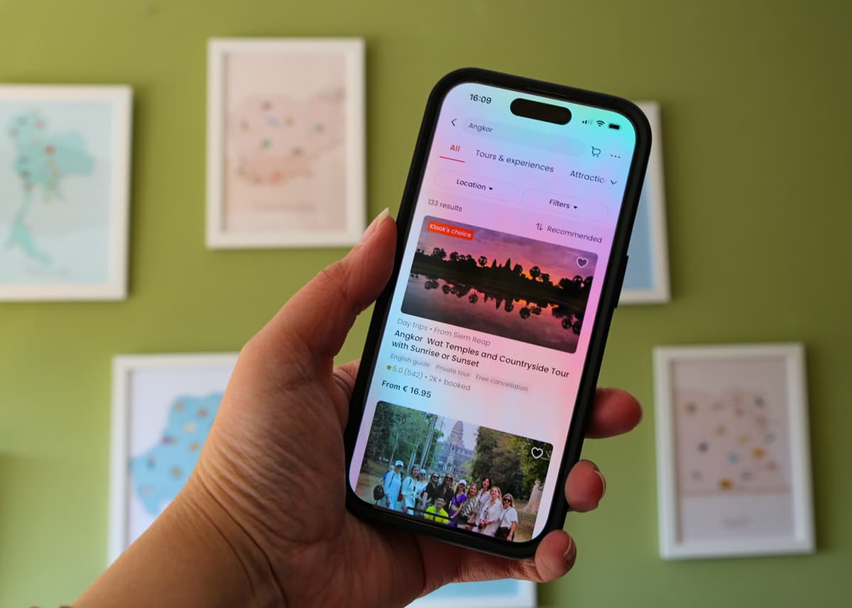a picture of an iphone with the Klook app open with different ticket options on the screen