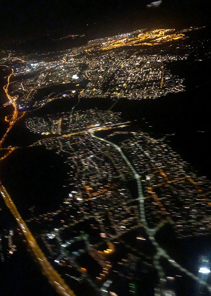Reykjavik photographed at night from a plane. The city is lit up.