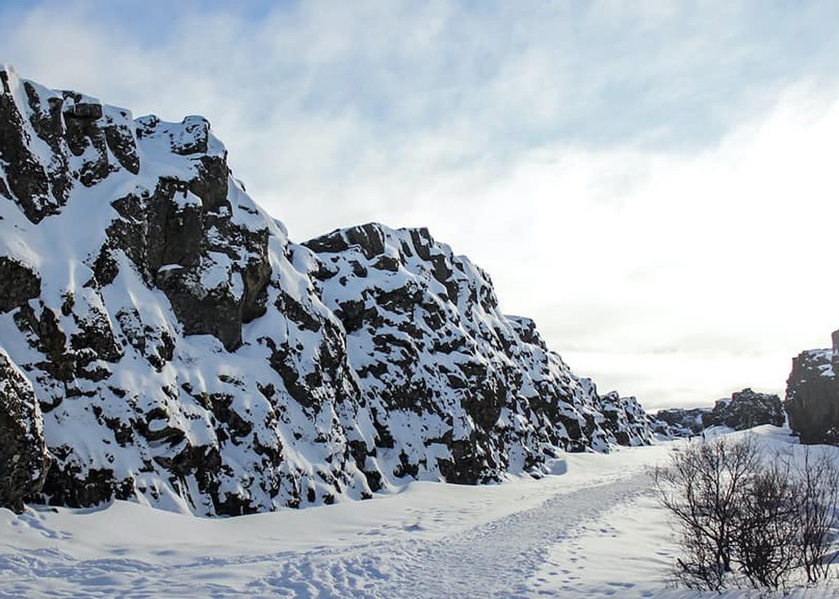 Snow covered mountain in Thingvellir NP under white clouds during daytime