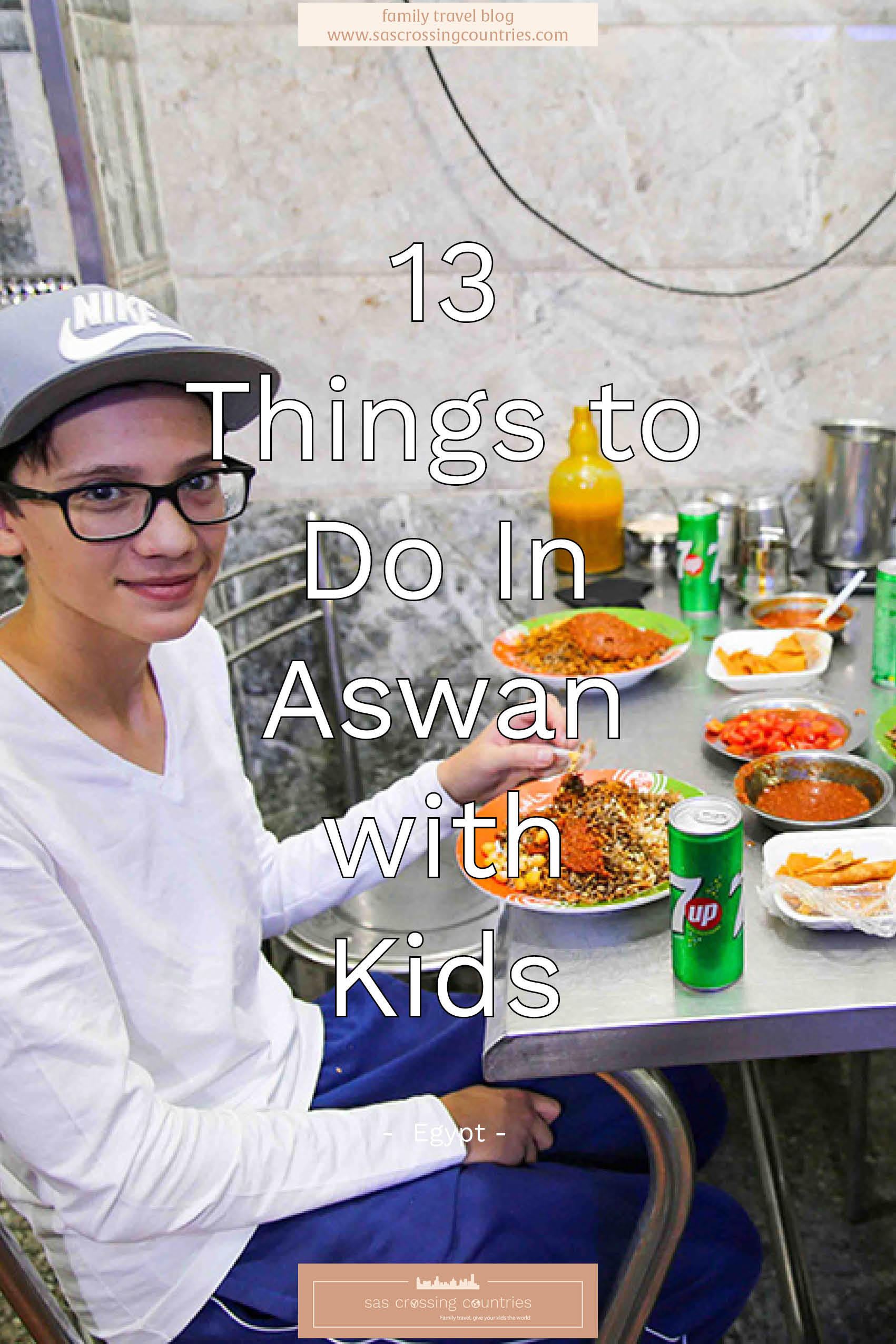 Cover image for a family travel blog post titled "13 things to do in Aswan with kids" showcasing a boy posing with a plate of koshari. The blog URL "www.sascrossingcountries.com" is visible at the bottom.